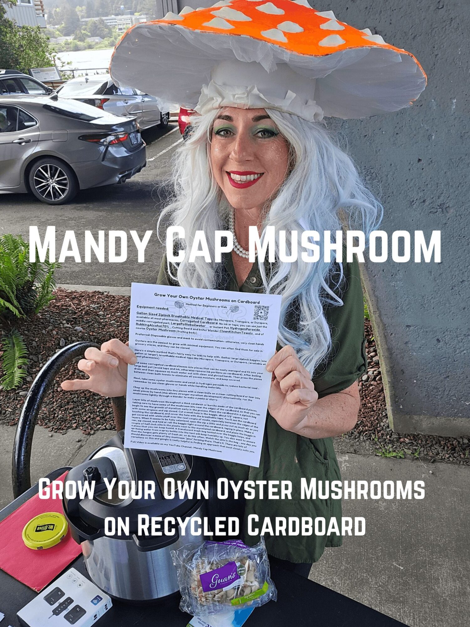 Woman with long white hair wearing a mushroom-shaped hat, holding a paper, smiling outdoors, with cars in background.