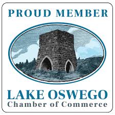 A stone tower with two arched openings, set against a cloudy sky, surrounded by trees, with text indicating pride in Lake Oswego Chamber of Commerce.