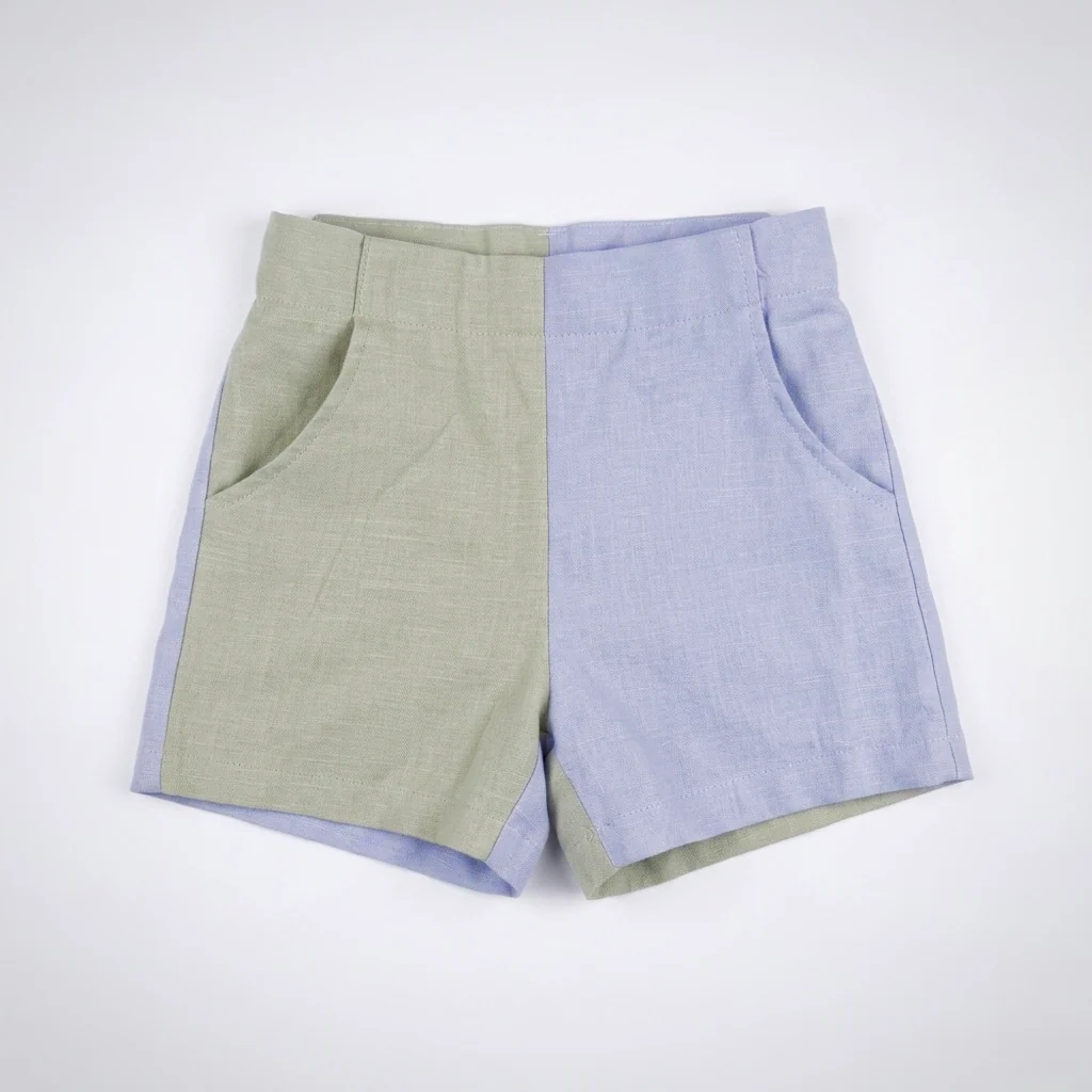 Two-tone shorts, one half light green and the other half light blue, with front pockets, on a white background.