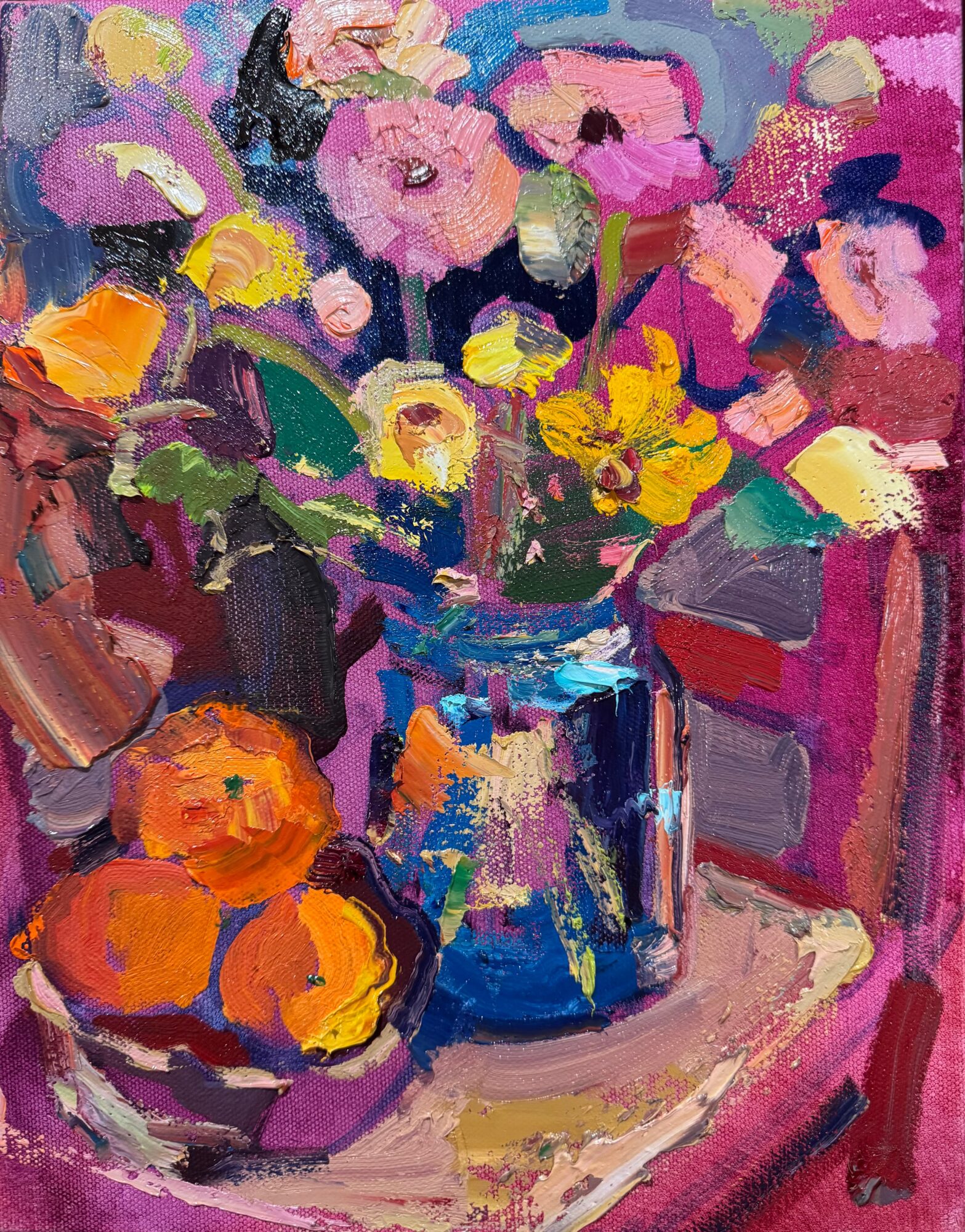 Colorful impressionist painting of a bouquet of pink, yellow, and purple flowers in a blue vase on a table with oranges nearby.