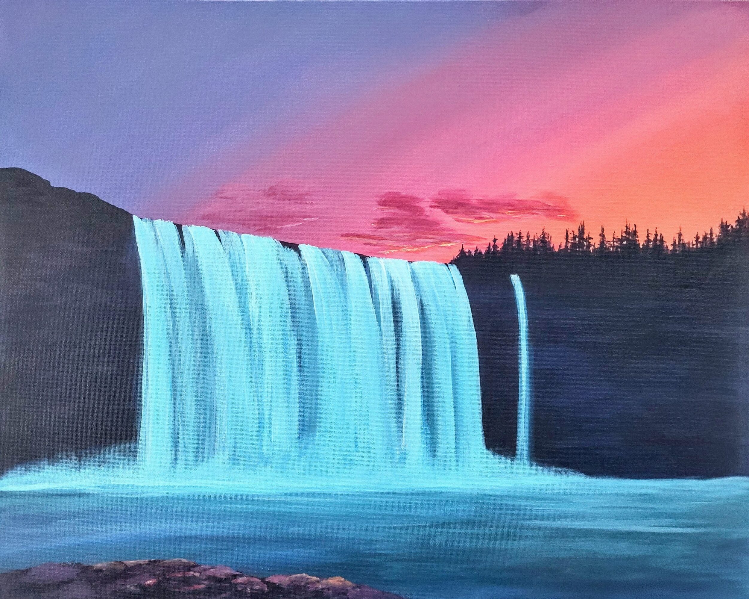 Waterfall flowing over a cliff with a colorful sunset sky in the background.