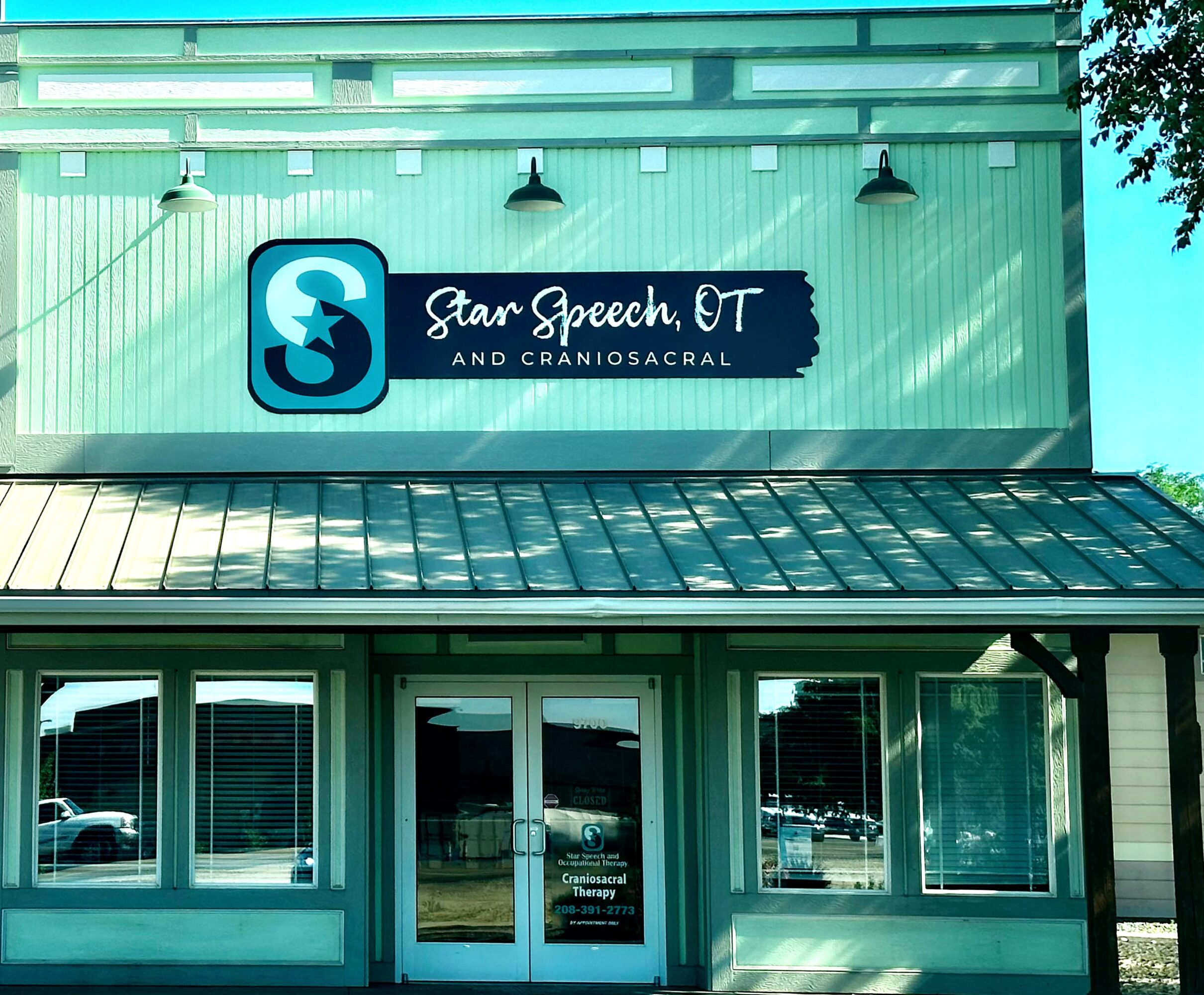 Storefront with a sign reading 'Star Speech, OT and Craniosacral' above glass doors and windows, exterior of a building.