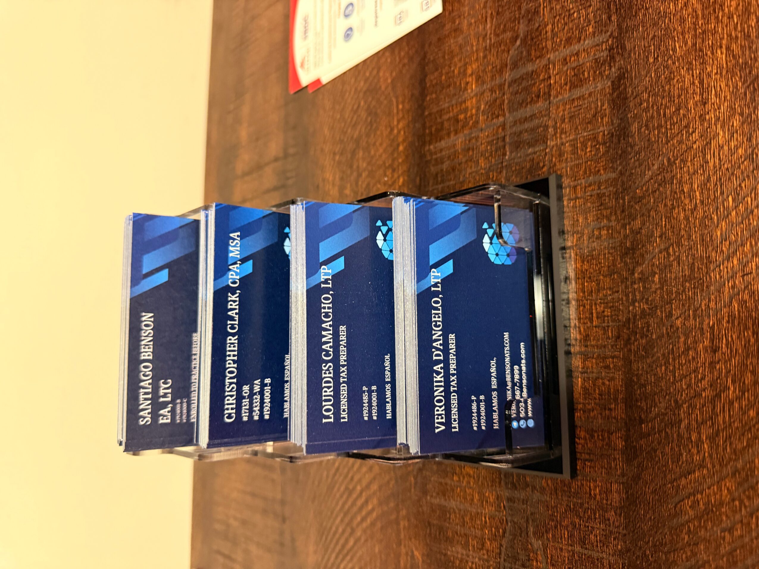 Three boxes of cigarettes stacked on a wooden surface, with text and logos visible on the packaging.