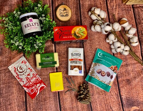 Assorted health and beauty products, snacks, and natural elements on a wooden surface.