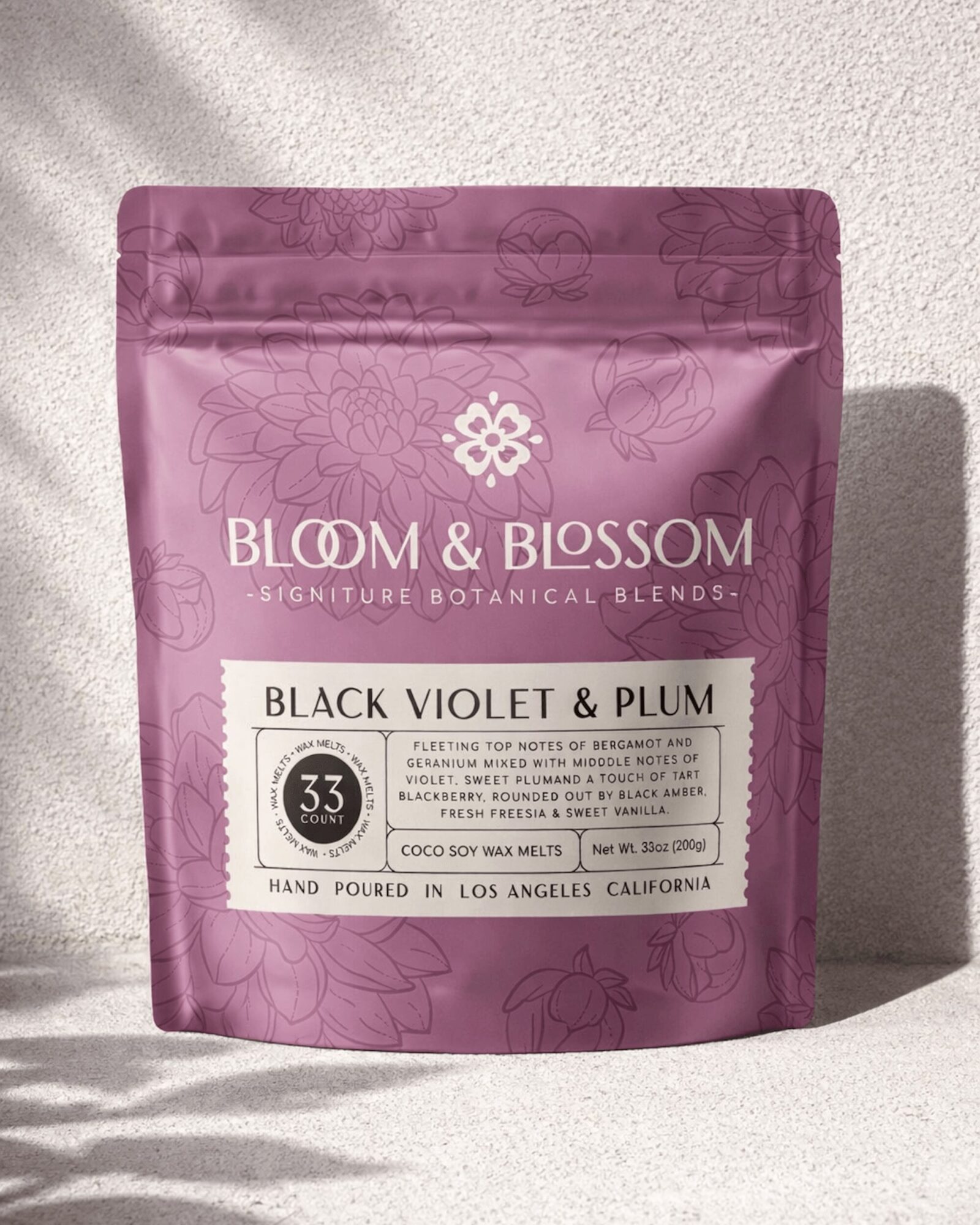 Pink resealable bag with white label, text, and floral design, standing on a light surface with shadow, product name and details.