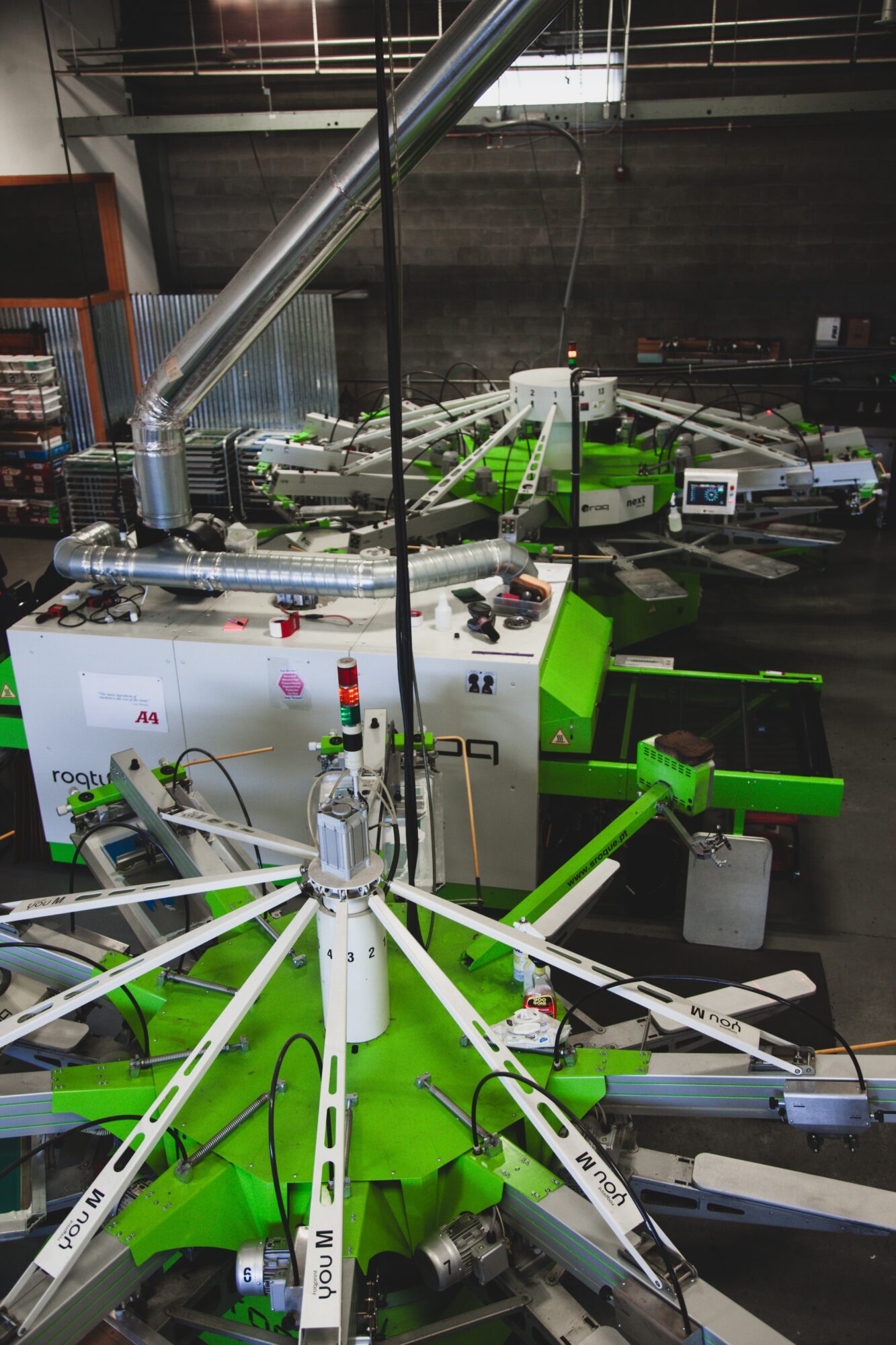 Laboratory equipment with green and white components, tubes, and machinery in a scientific setting.