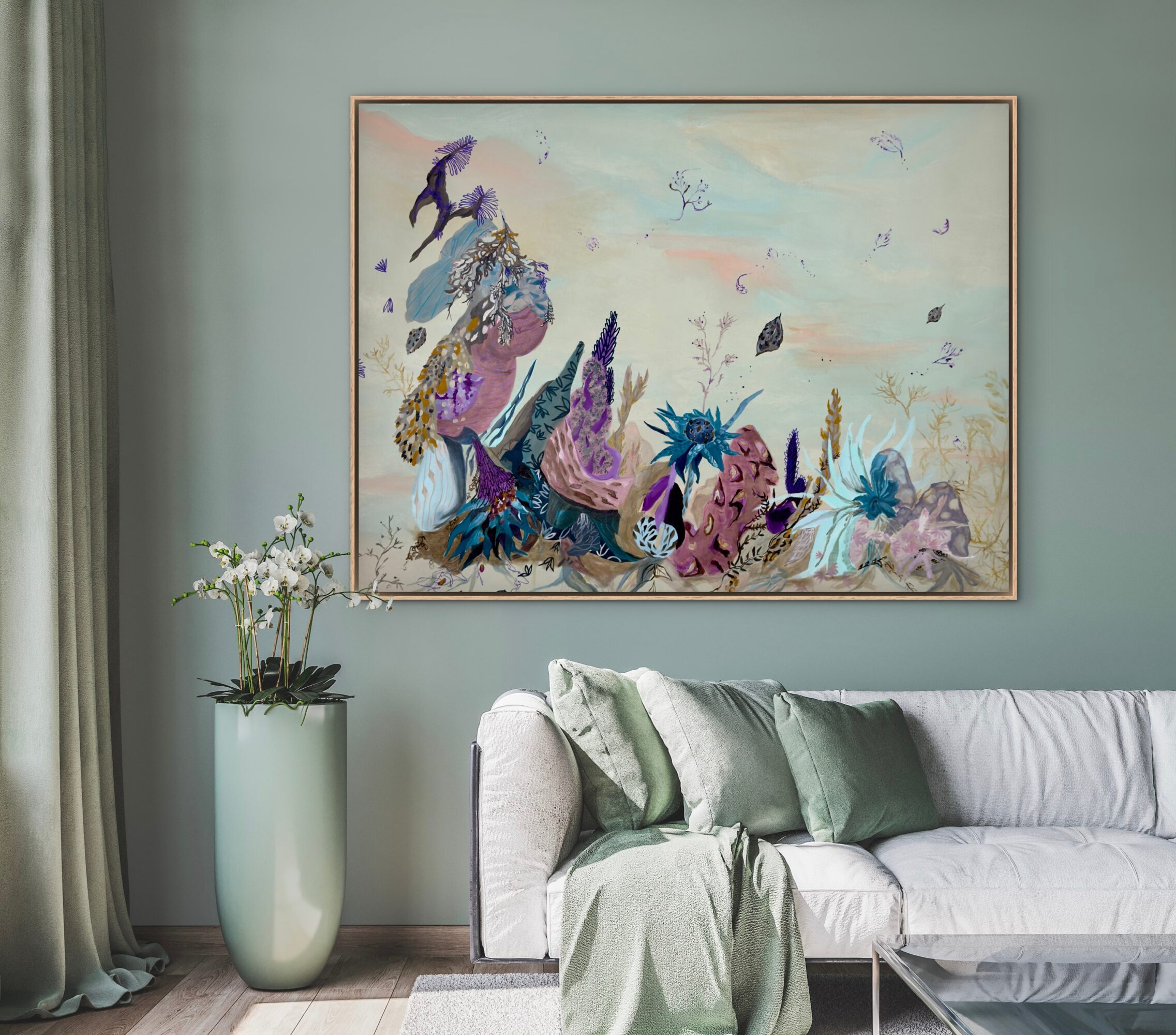 Living room with a large colorful abstract painting, a white sofa with green pillows, and a tall plant in a white vase.