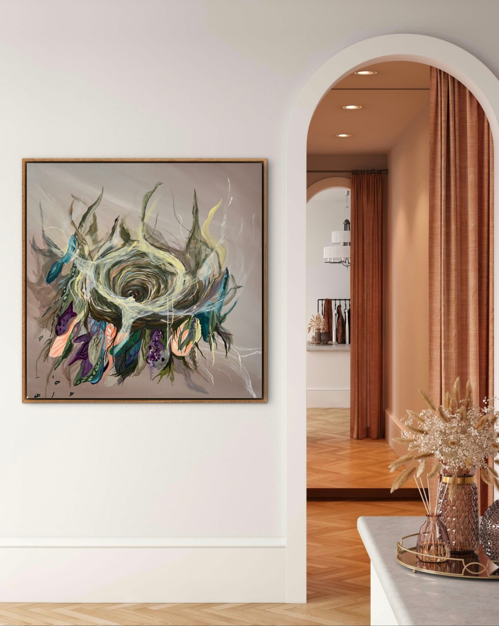 Interior view with a framed abstract painting on a white wall, arched doorway, and a table with dried flowers.