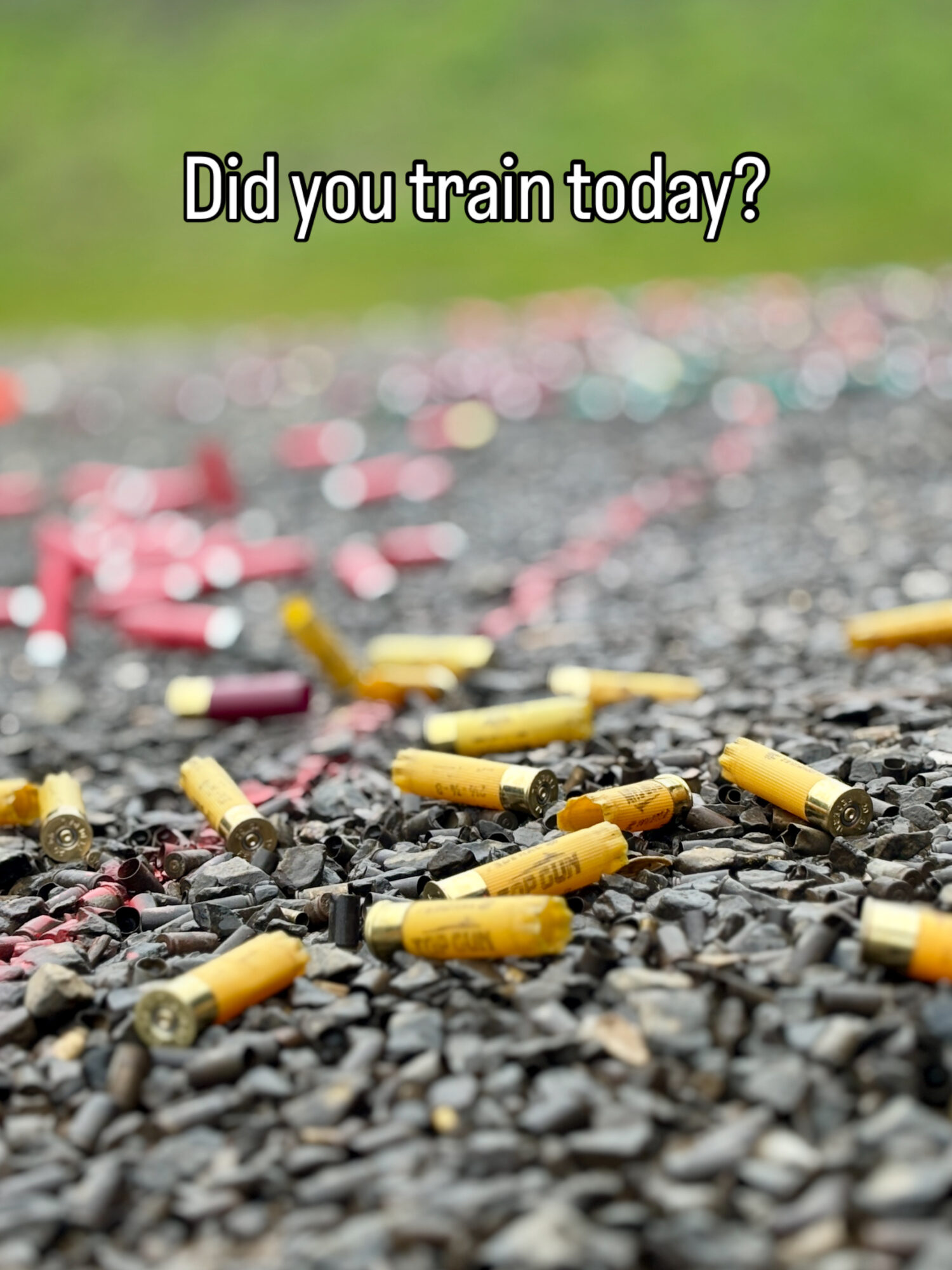 Cigarette butts scattered on a gravel surface with a blurred green background, and text asking if someone trained today.