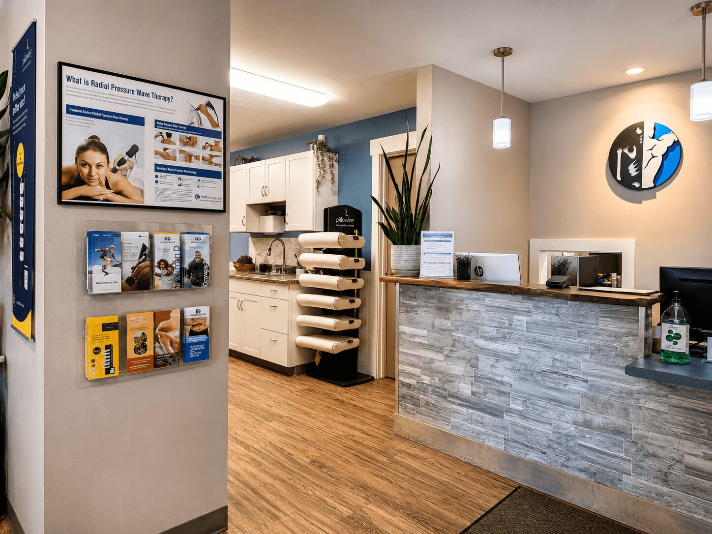 Reception area with a curved stone counter, a wall-mounted logo, and a waiting area with magazines, wooden flooring, and modern lighting.