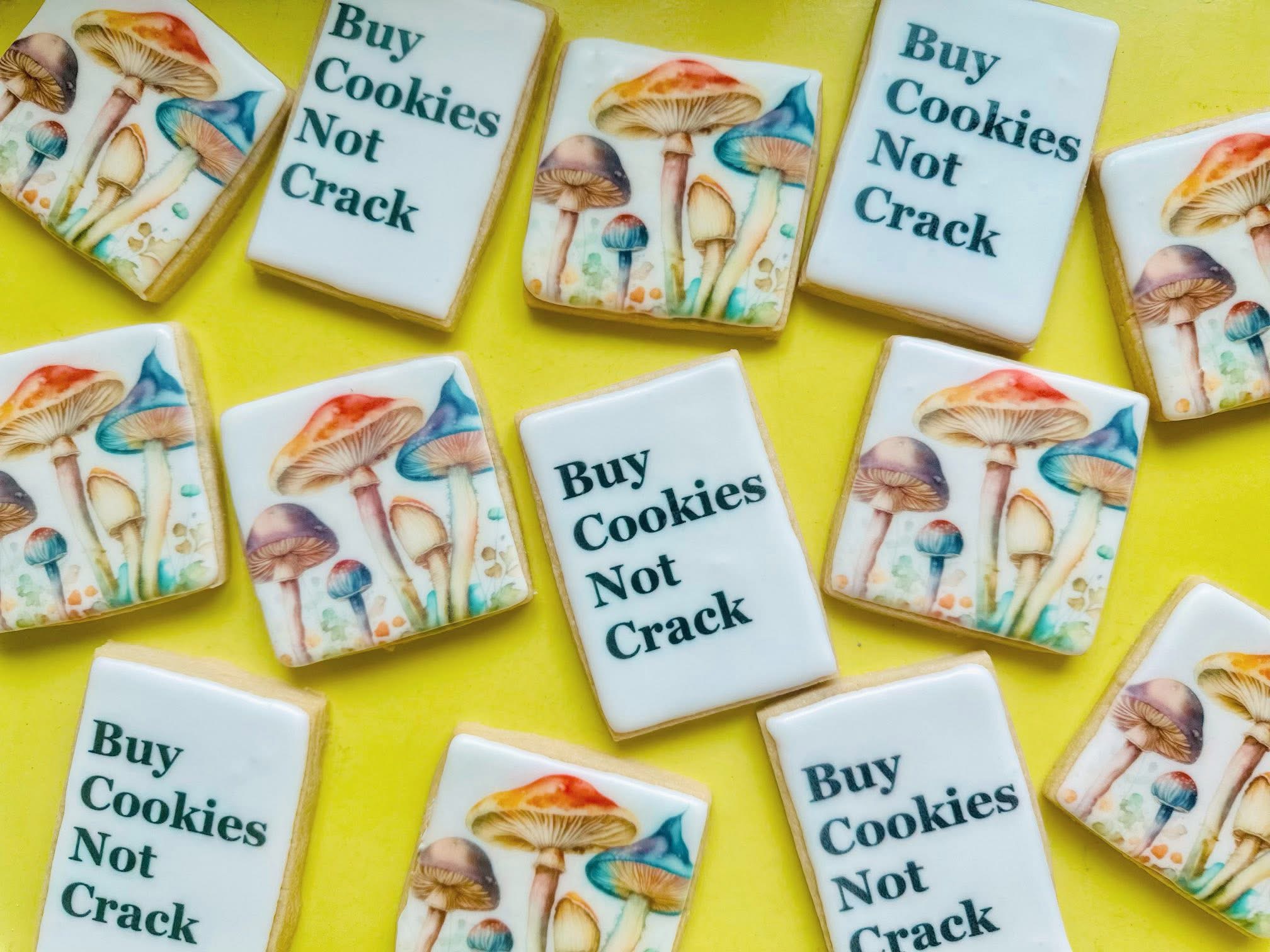 Multiple matchboxes with mushroom illustrations and a message, scattered on a yellow surface.