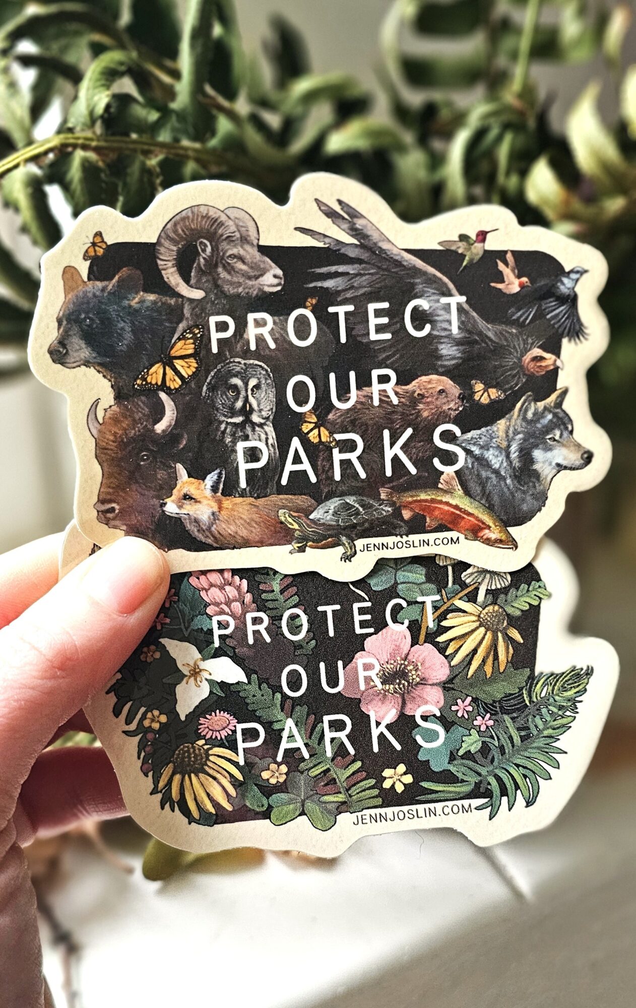 Two stickers with animals and plants, displaying the message