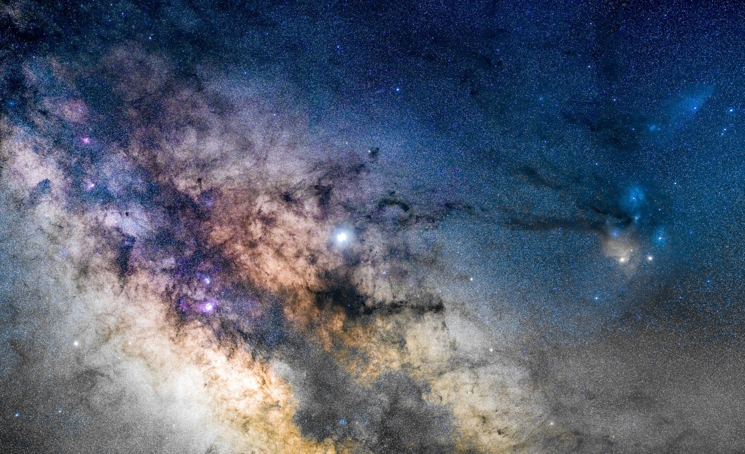 A view of the Milky Way galaxy with stars and cosmic dust in space.