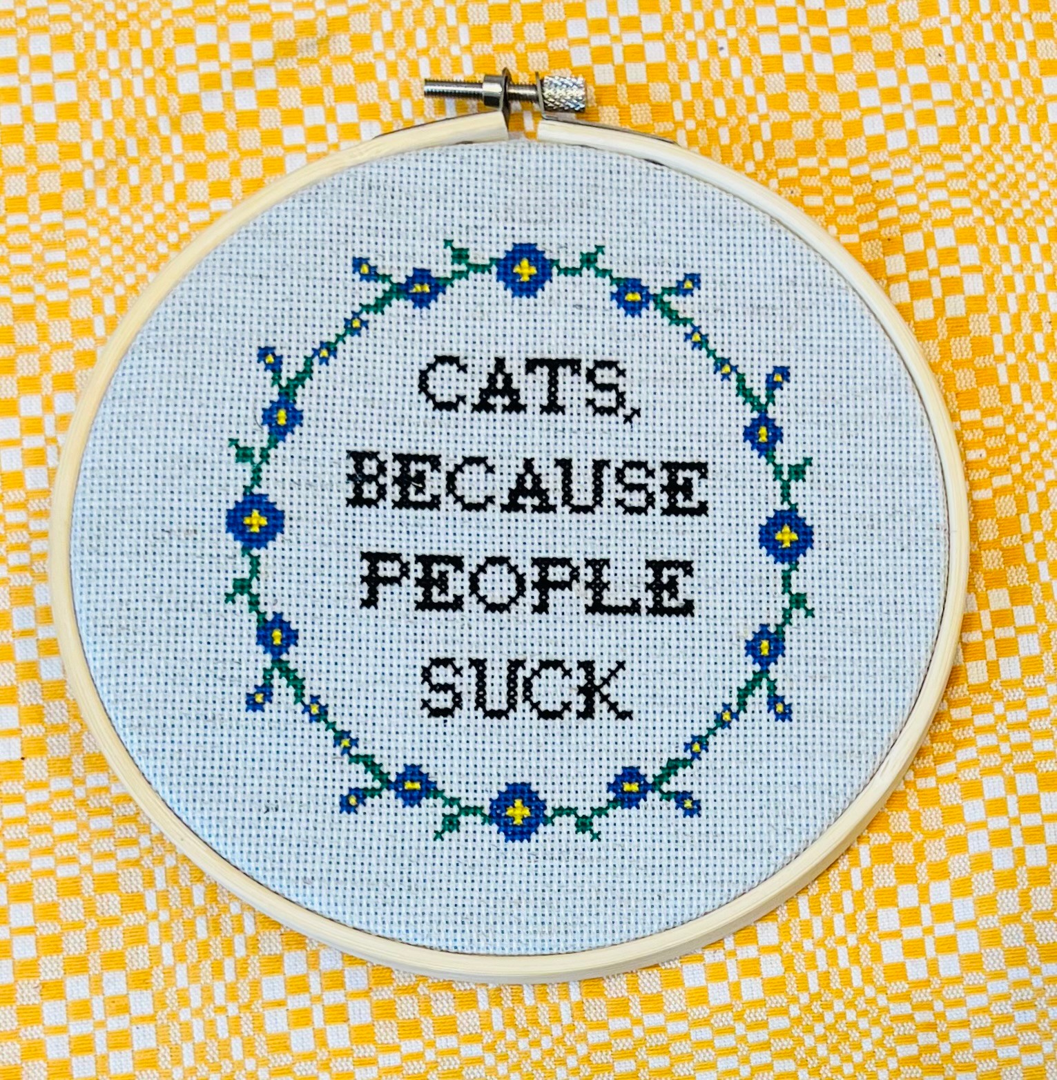 Cross-stitch embroidery with the text 