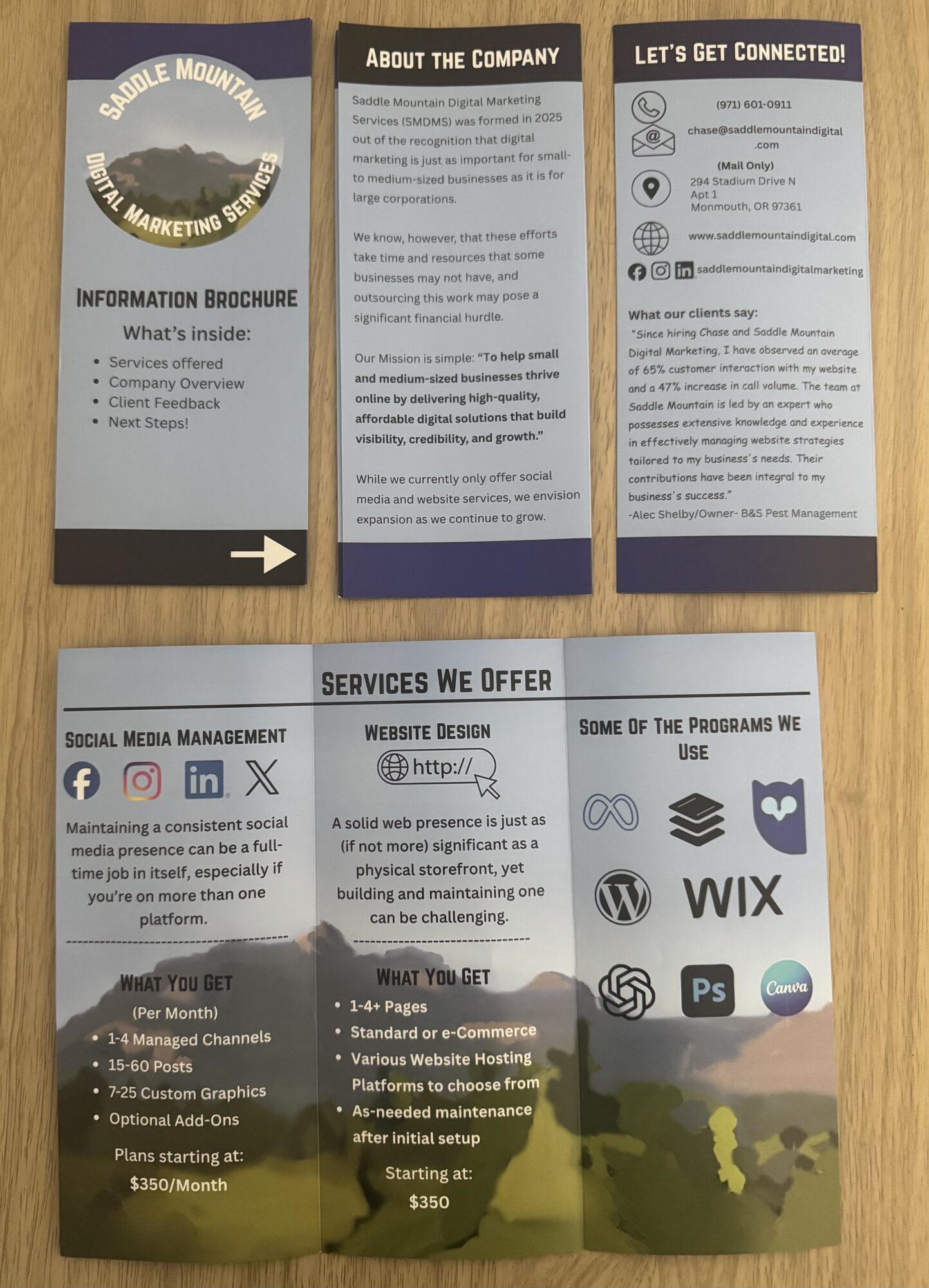 Three pamphlets with company information, services, and social media details, featuring mountain imagery and text sections, laid flat on a surface.