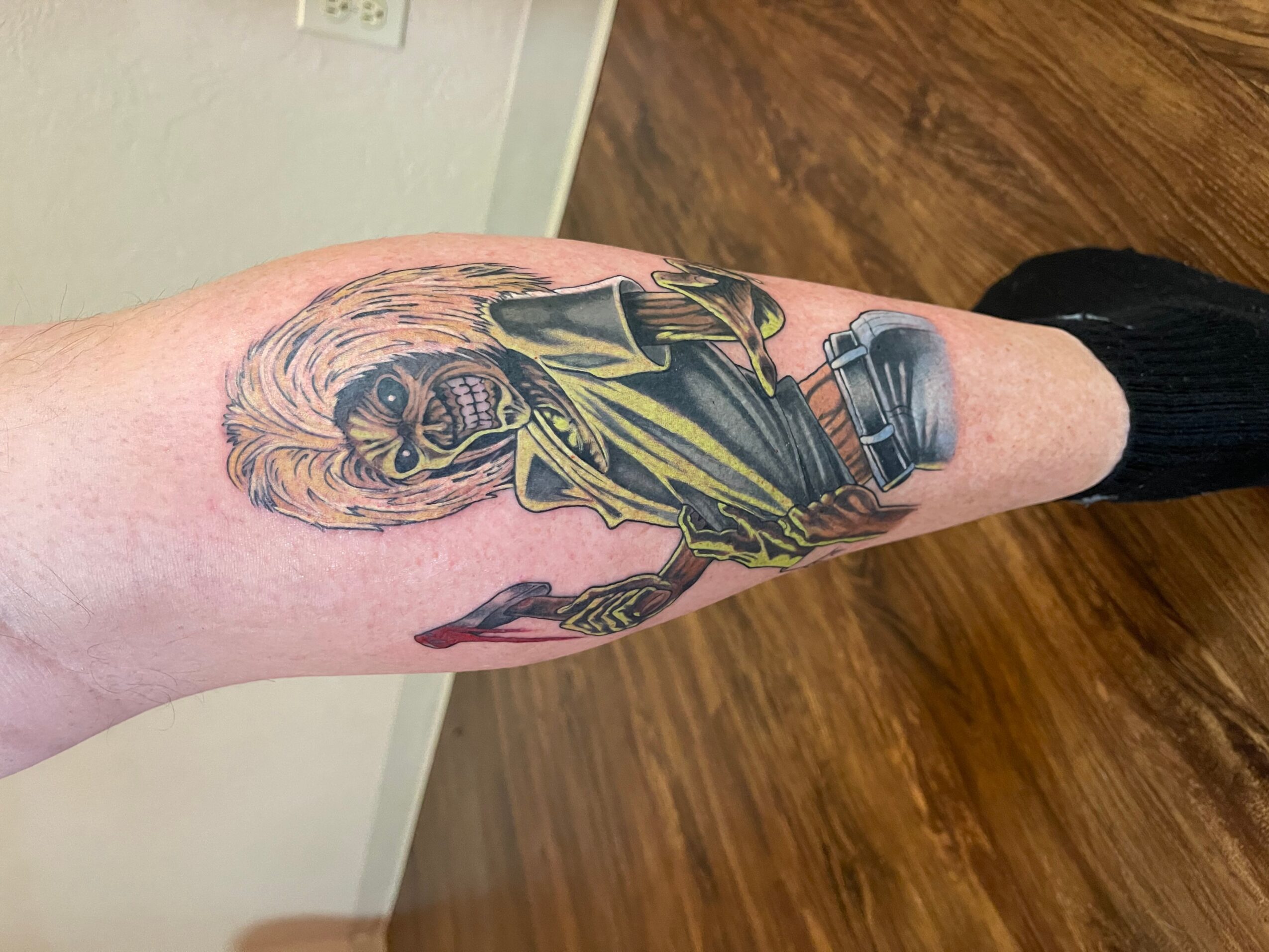 Tattoo of a woman with long hair, wearing a dress, on a person's forearm, with detailed shading and line work.