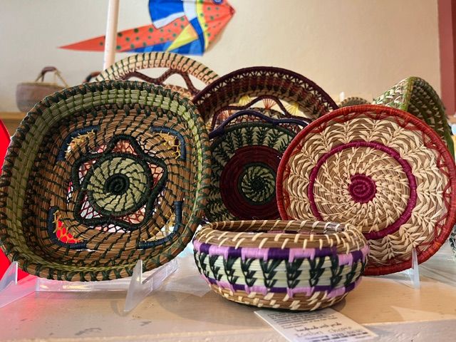Collection of woven baskets with colorful patterns displayed on a table.