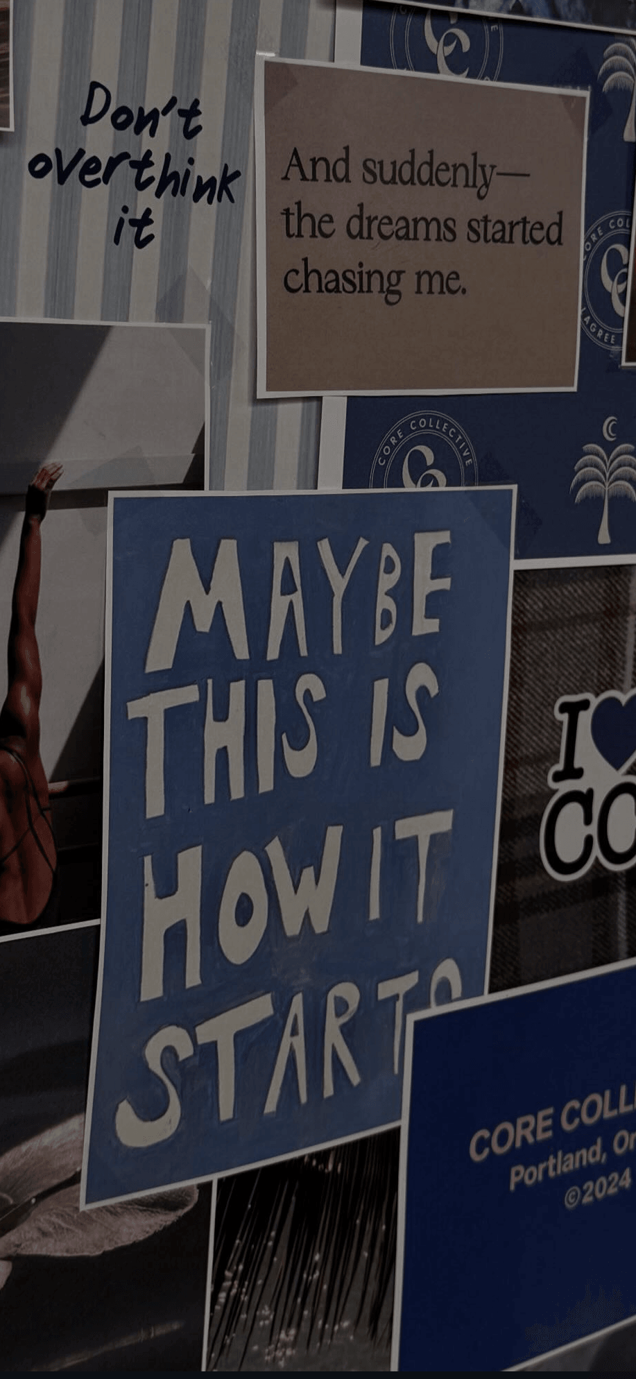 A person holds a blue sign with white text reading,
