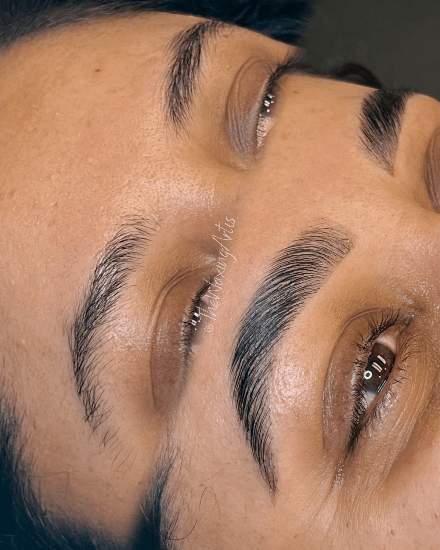 Close-up of a person's face showing well-groomed eyebrows and eyes, with the face tilted sideways.