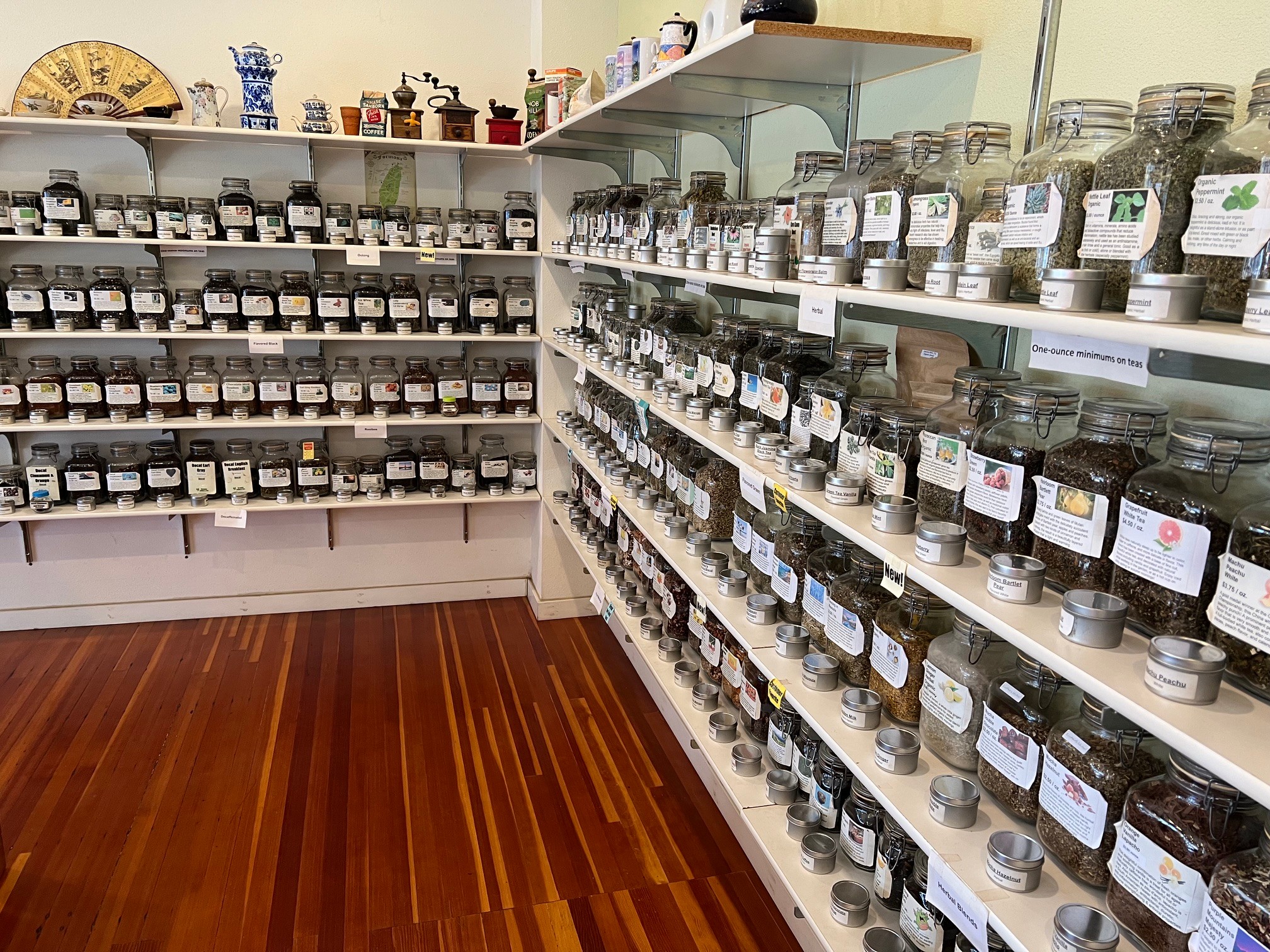 Shelves filled with jars and containers in a store, wooden floor, organized display.