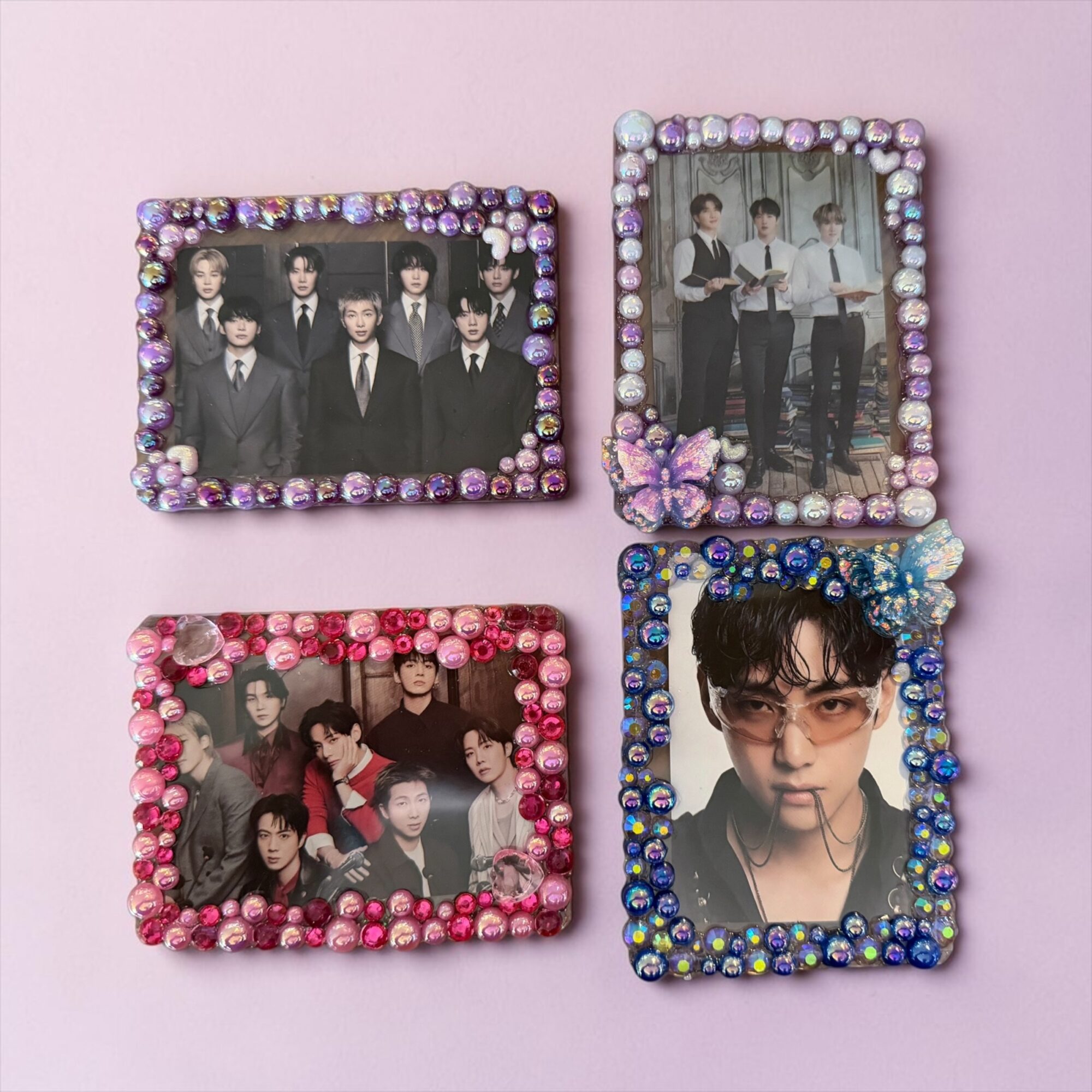 Four decorated photo frames with group and individual photos on a pink background.