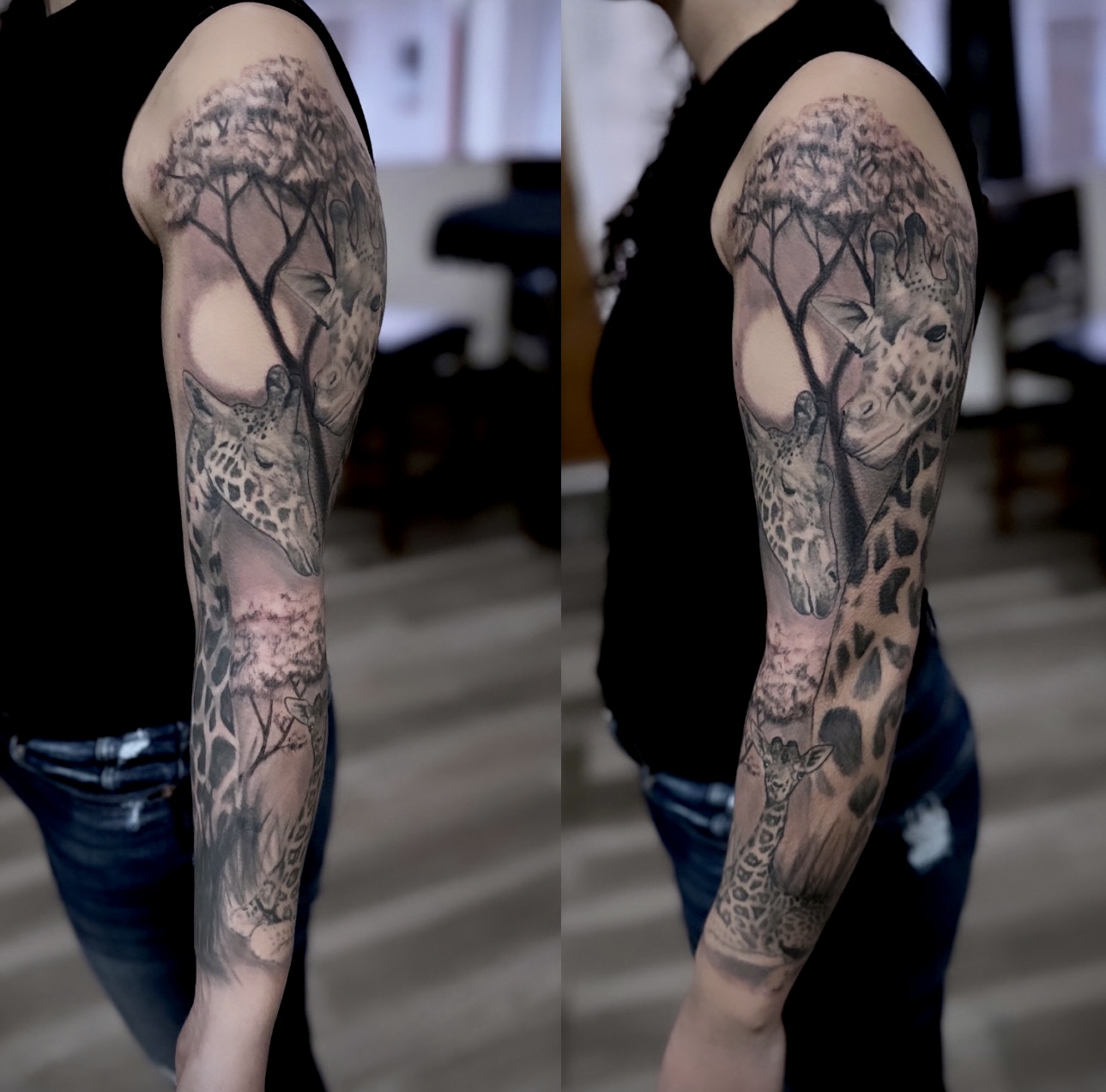 Tattooed arm with trees, giraffe, and landscape designs, seen from side view, person wearing black top and jeans.