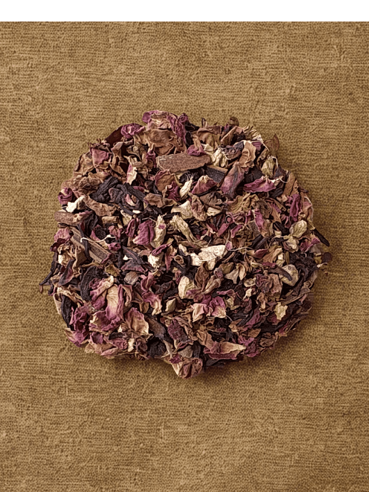 A round cluster of dried purple and beige flower petals on a brown textured background.