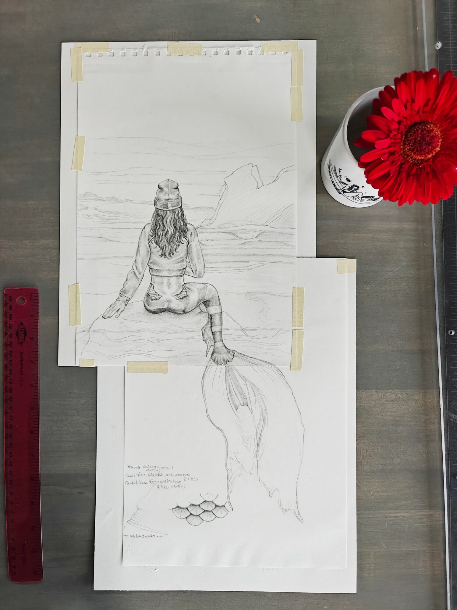 Sketch of a mermaid sitting on a rock by the sea with a whale tail, ocean, and mountains in background, next to a red flower in a white cup.