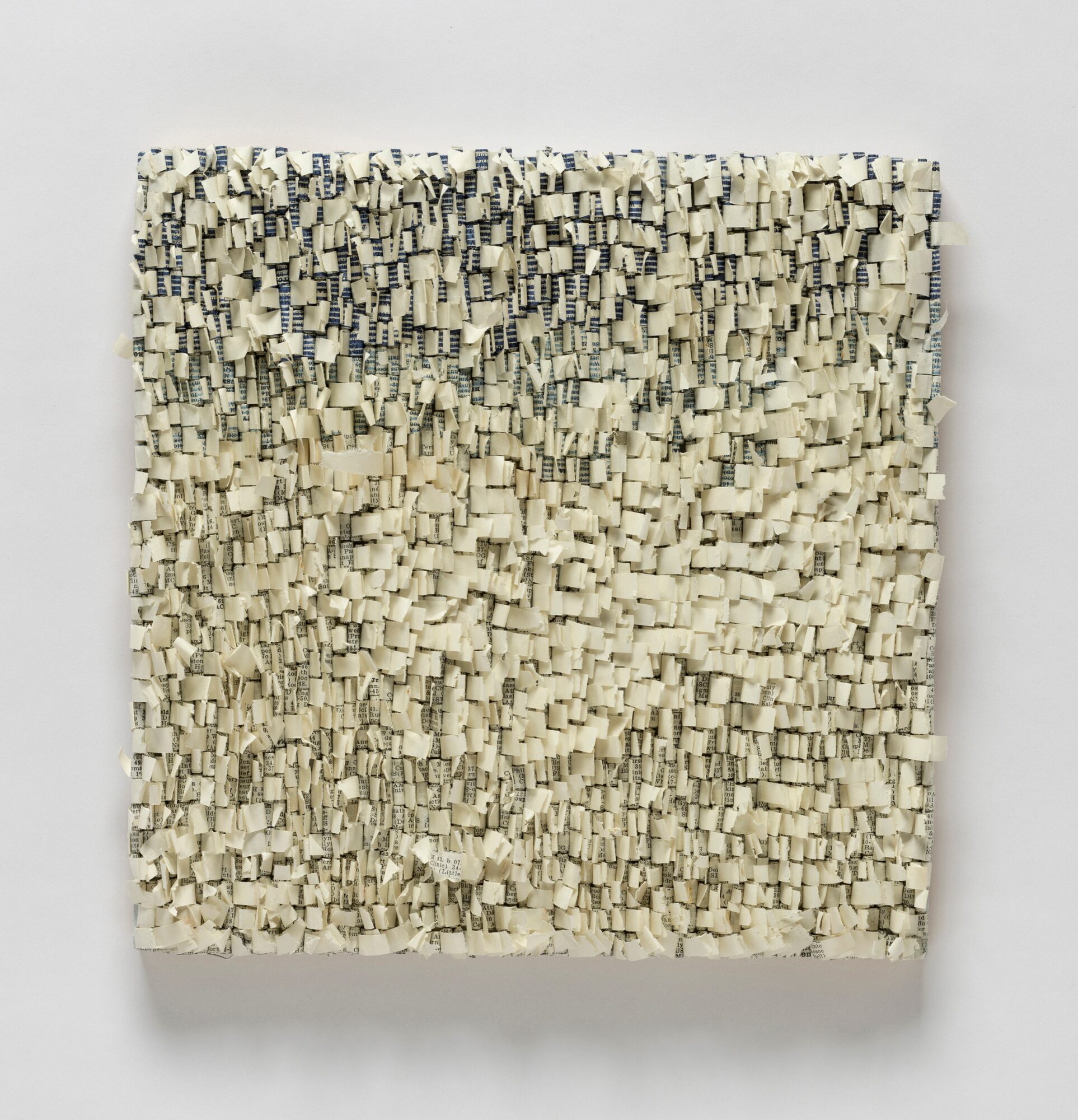 Textured square artwork with small, irregular, cream-colored blocks on a white background.