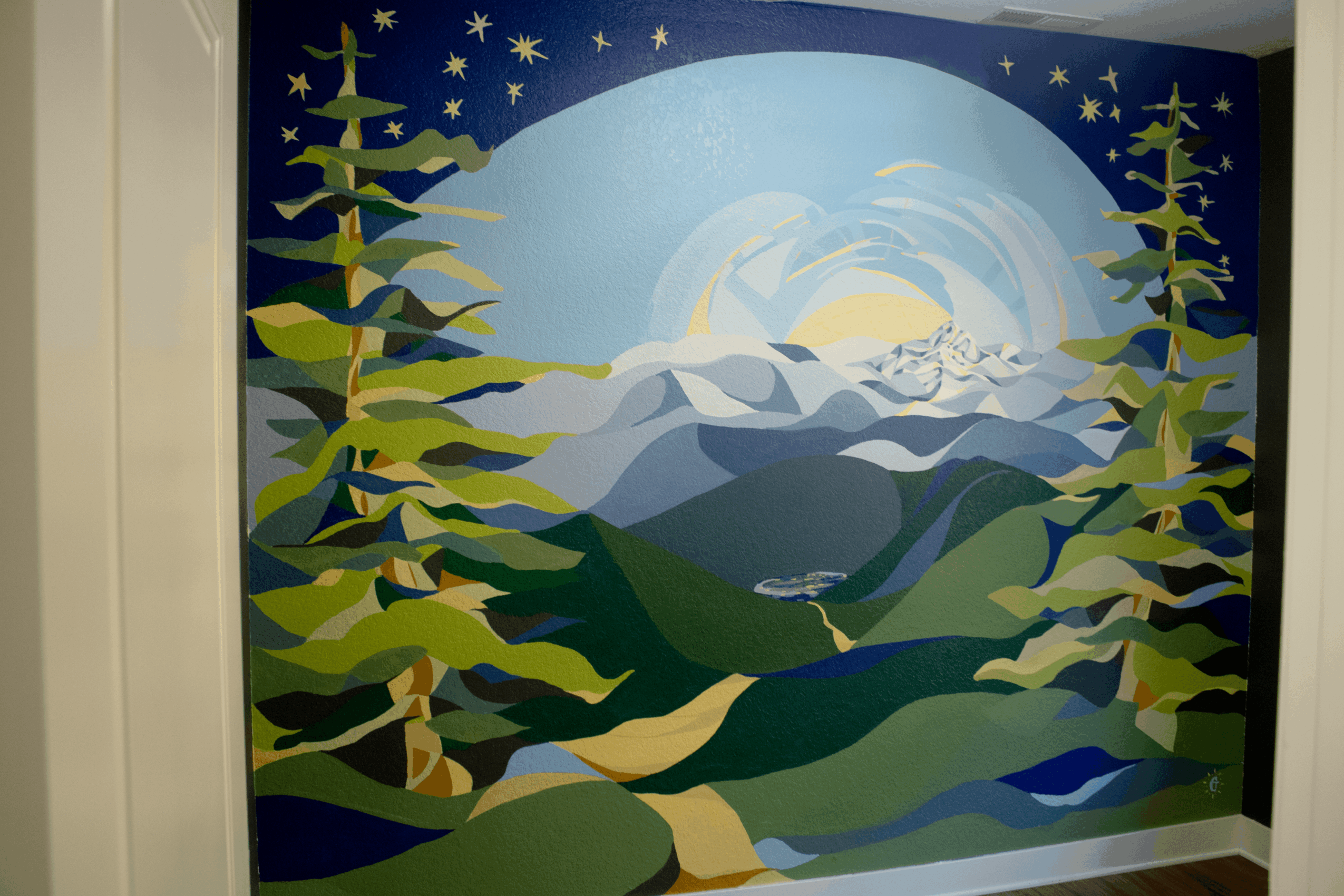 Colorful mural of mountains, trees, and a sky with stars and a moon, depicting a natural landscape scene.