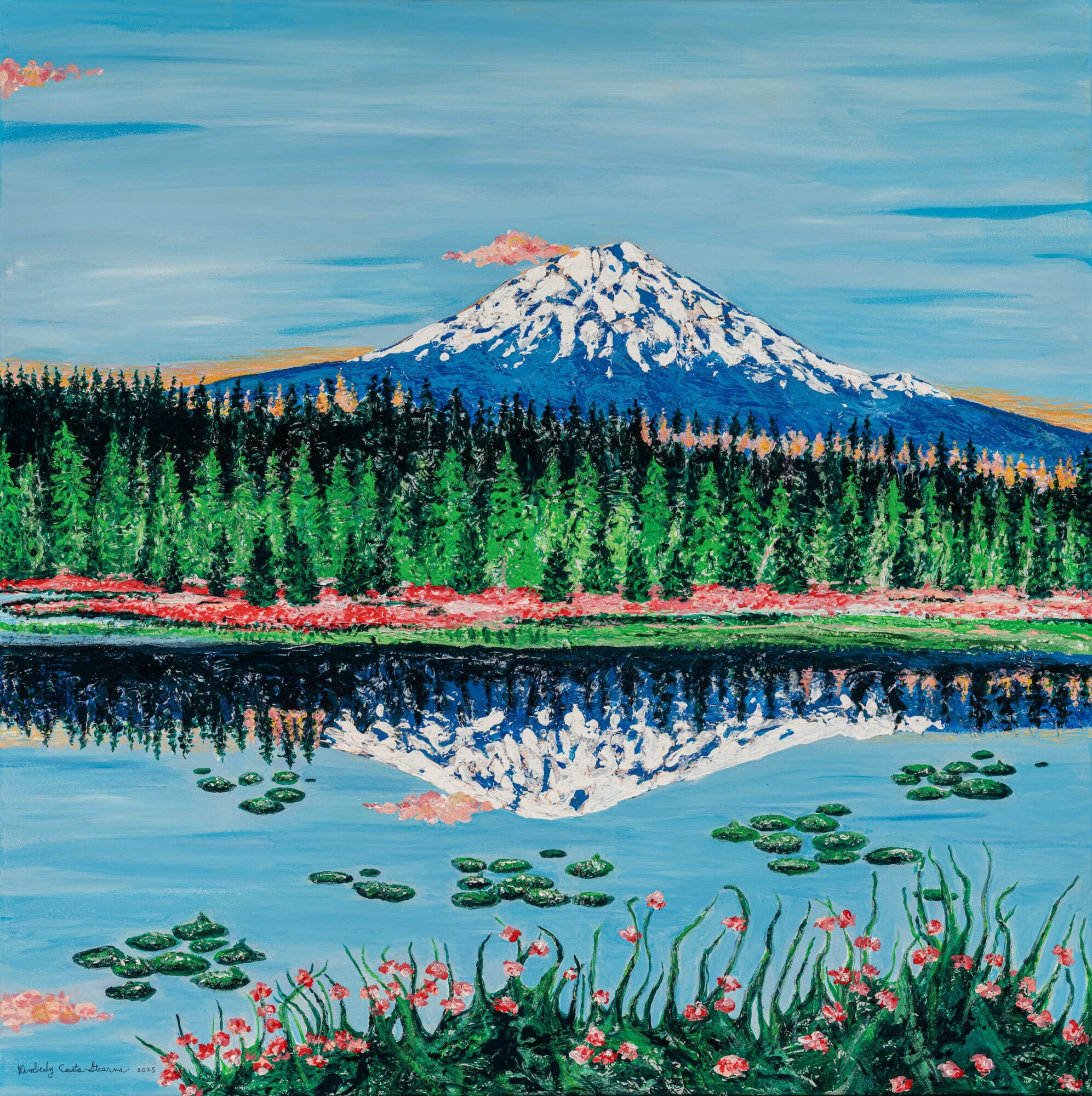 Snow-capped mountain with forest and lake, reflection of mountain in water, pink flowers in foreground, blue sky.
