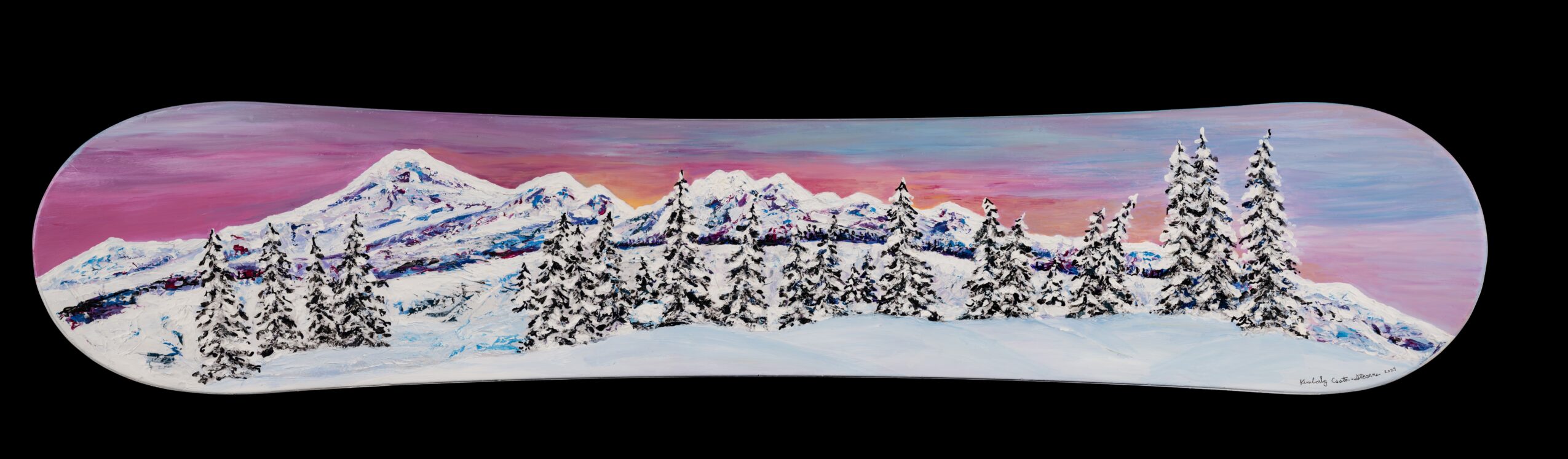 Panoramic snowy mountain landscape with trees and a pink and purple sky, viewed through a rounded rectangular frame.