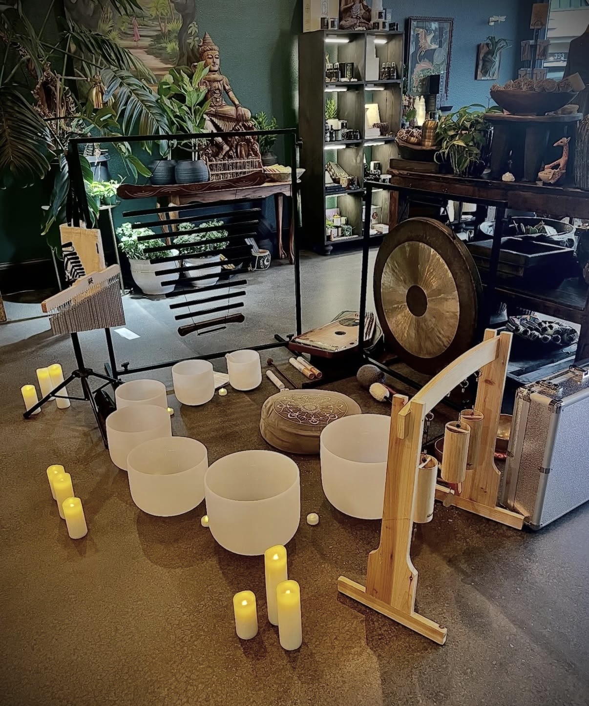 Room with musical instruments, candles, and decorative items on shelves and tables, in a cozy, eclectic space.