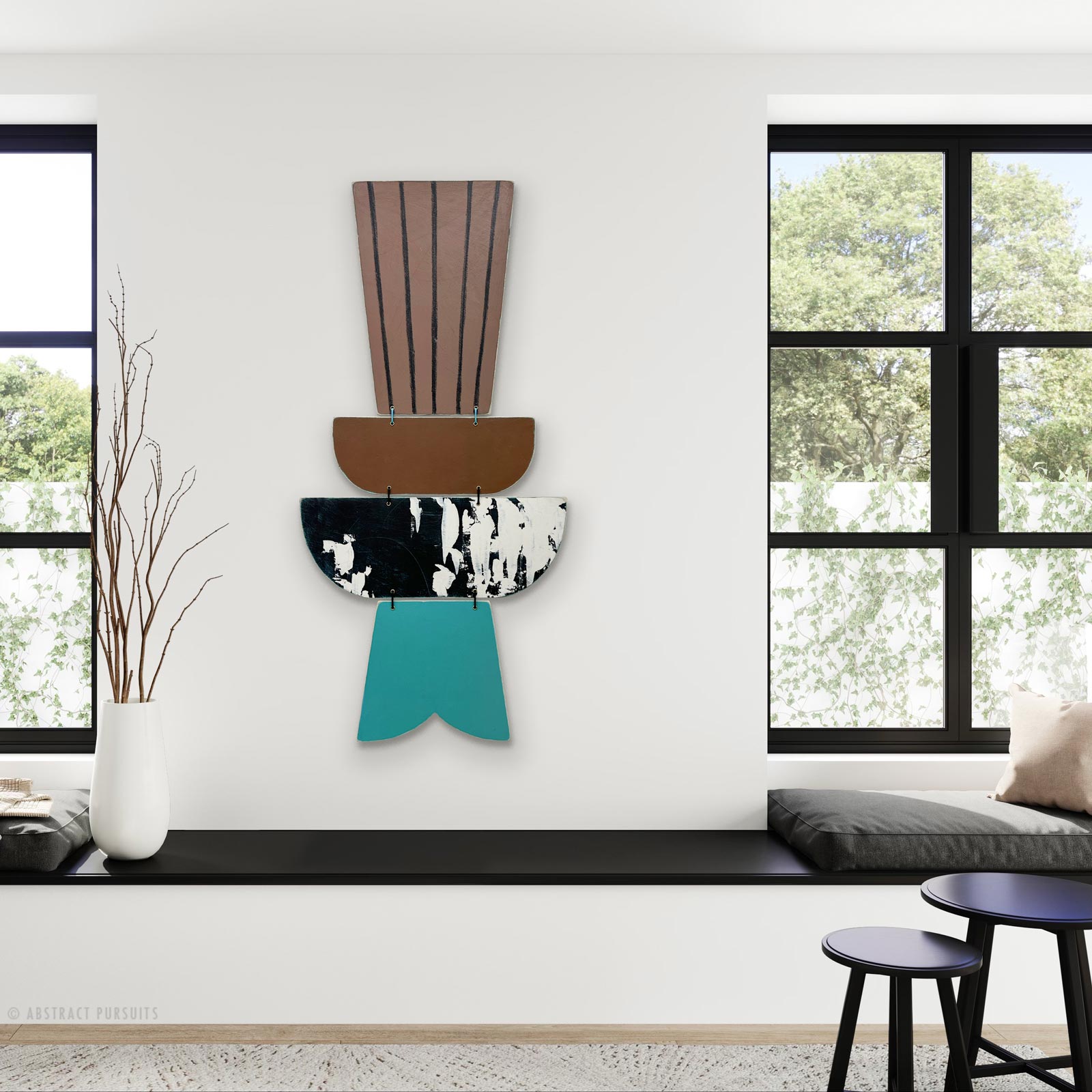 Decorative wall art with vertical brown, black and white, and teal elements, next to a window with trees outside.
