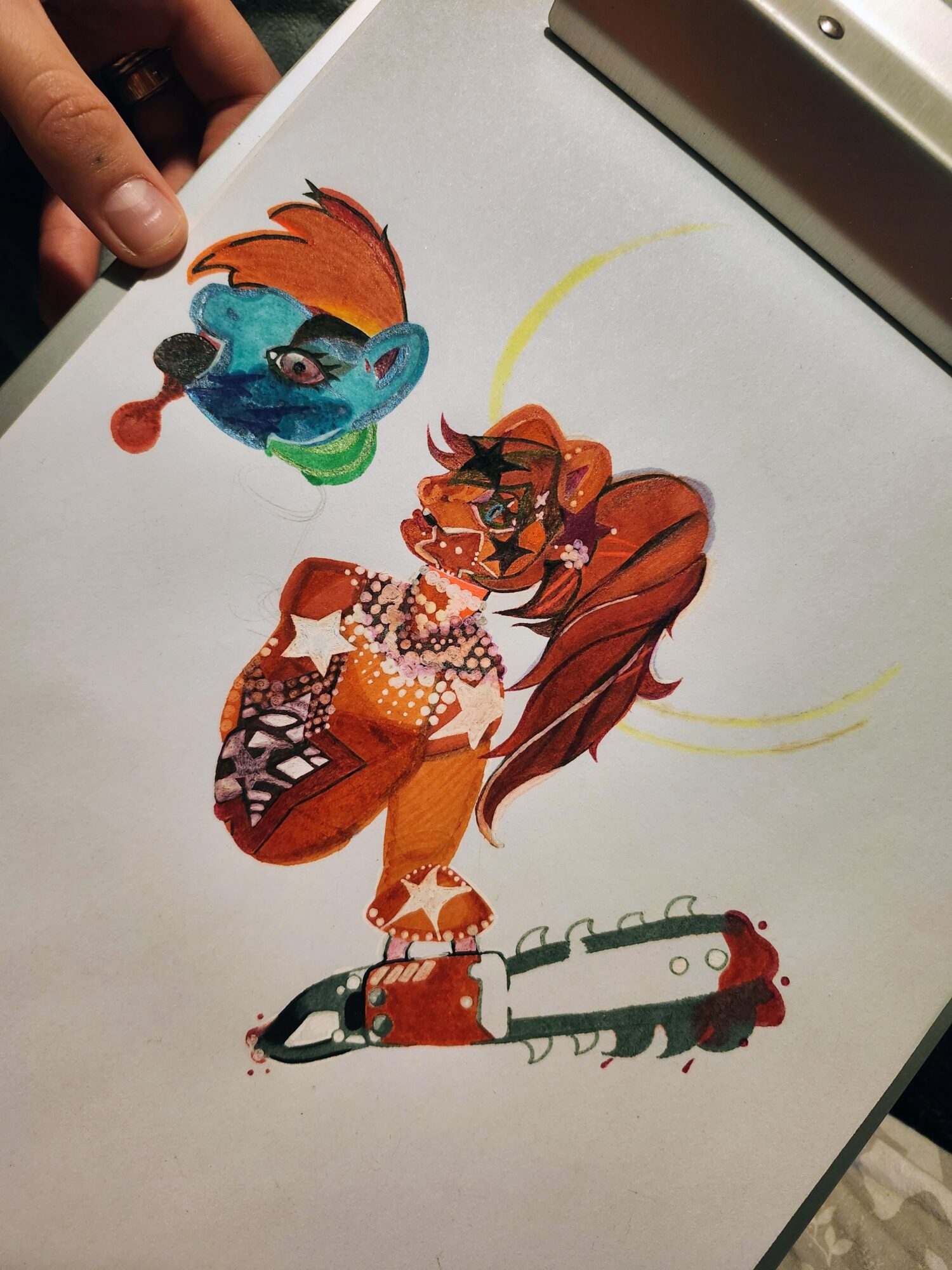 Colorful drawing of a feline character with long hair, a blue creature with glasses, and a chainsaw, on white paper.