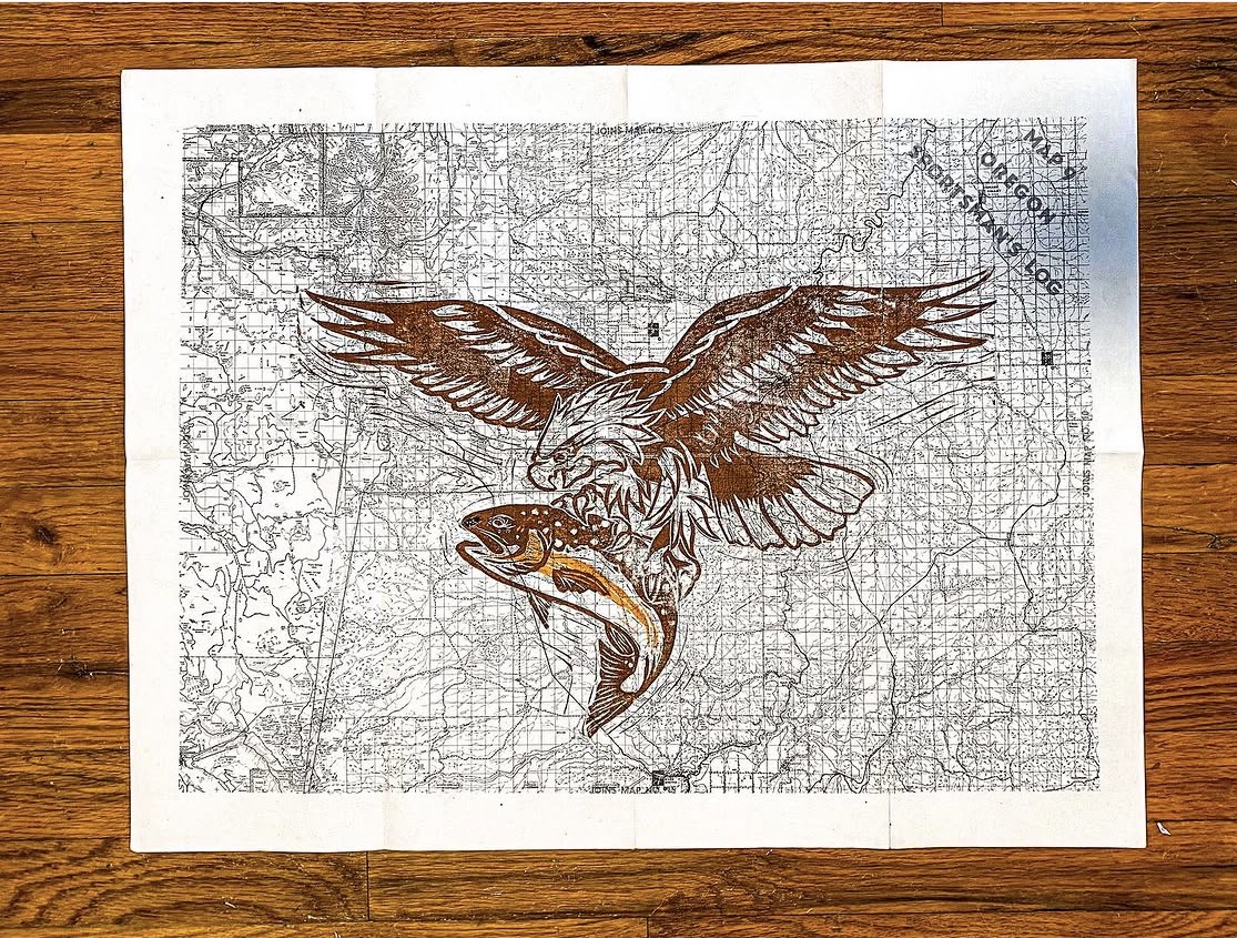 Map with an eagle illustration holding a fish in its talons, overlaid on a detailed map background.