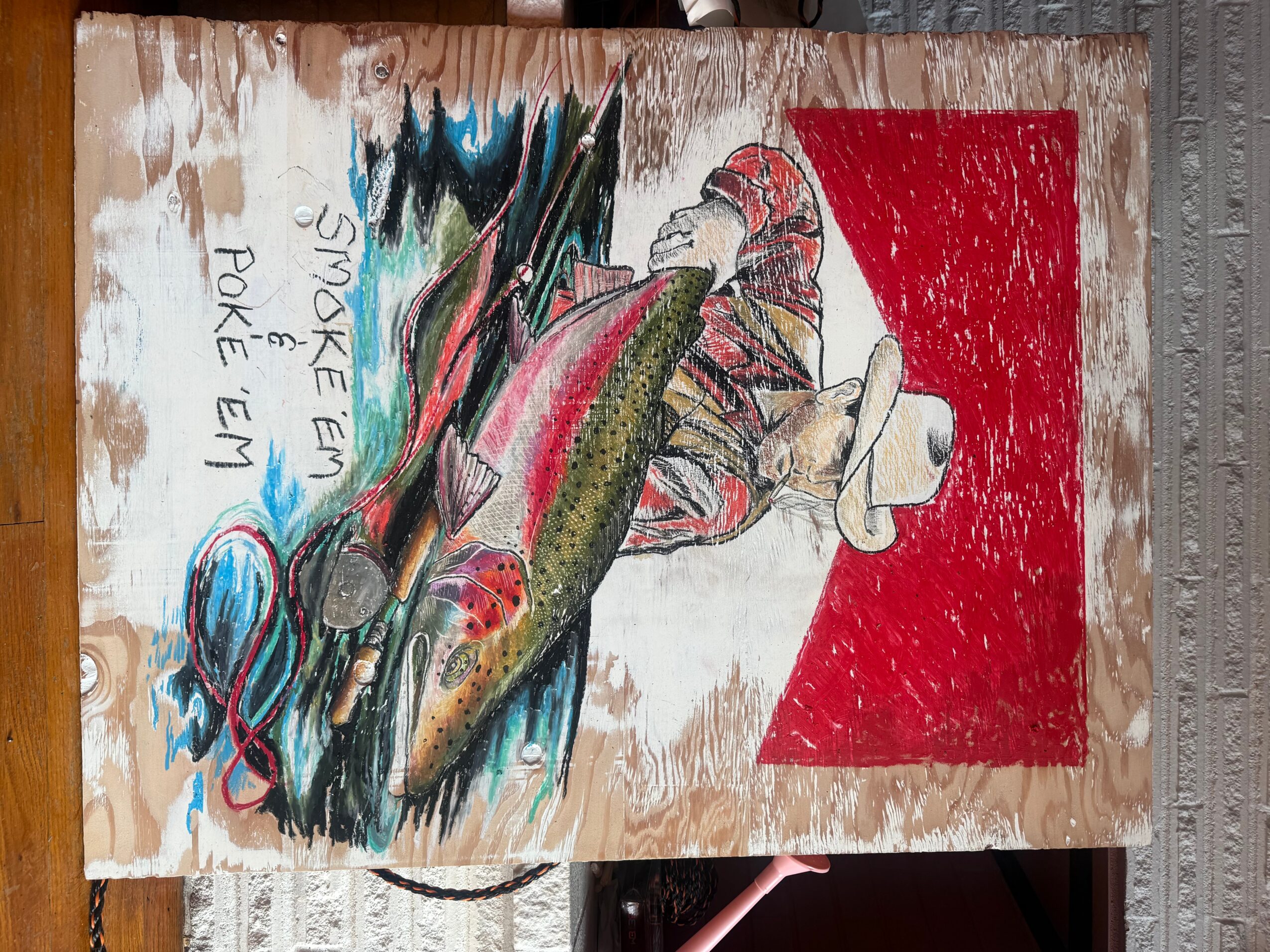 Person holding a large fish with a fishing rod, with a red background and handwritten text on the left side.