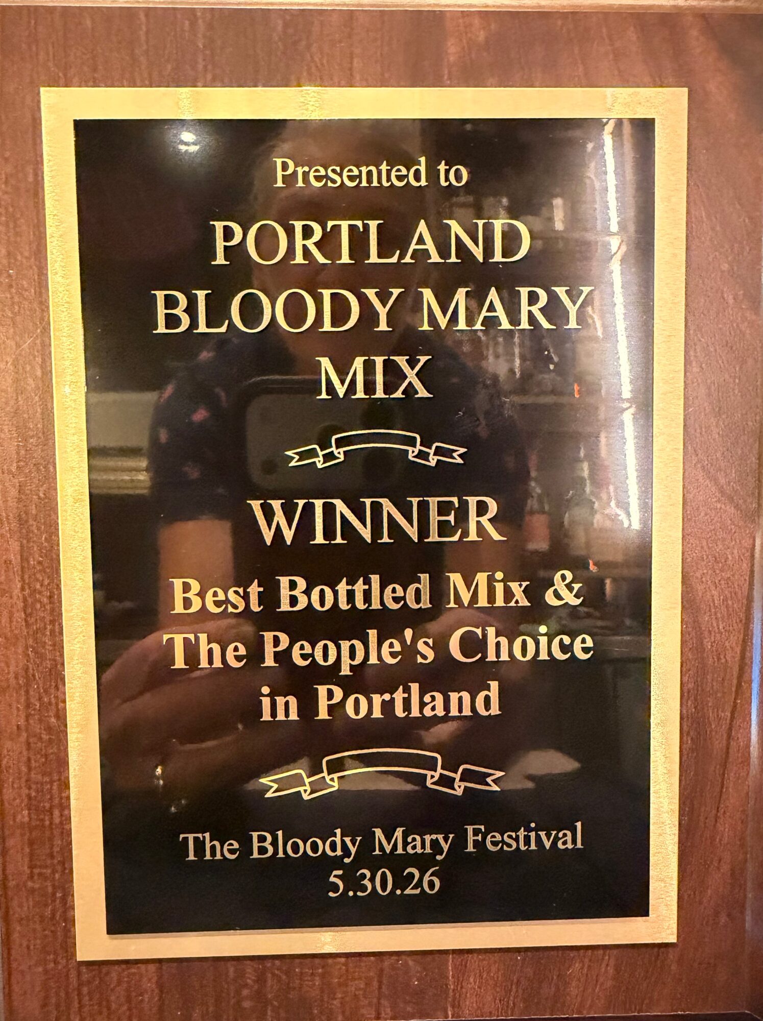 Framed award sign naming Portland Bloody Mary Mix as winner of a bottled mix competition.